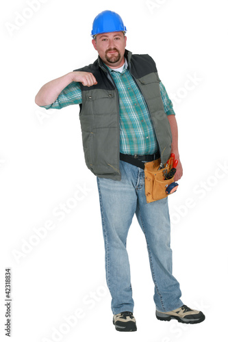 Portrait of a tradesman holding his arm up © auremar