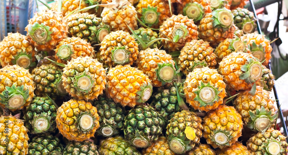 pineapples at a market stall.
