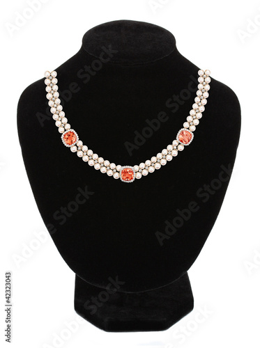 Pearl necklace with stones on black mannequin isolated on white
