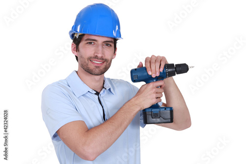 Man with helmet and drill