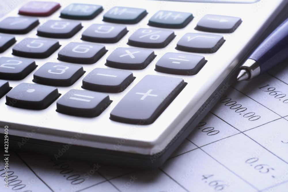 pen and calculator on business paper pen and calculator on business paper