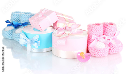 baby boots, pacifier, gifts and blank postcard isolated