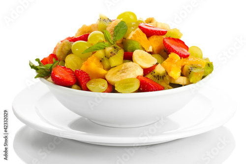 bowl with fresh fruits salad isolated on white