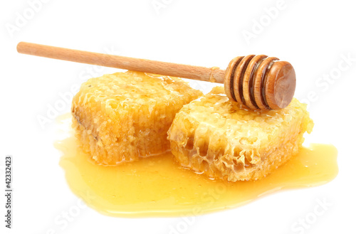 golden honeycombs and wooden drizzler with honey isolated