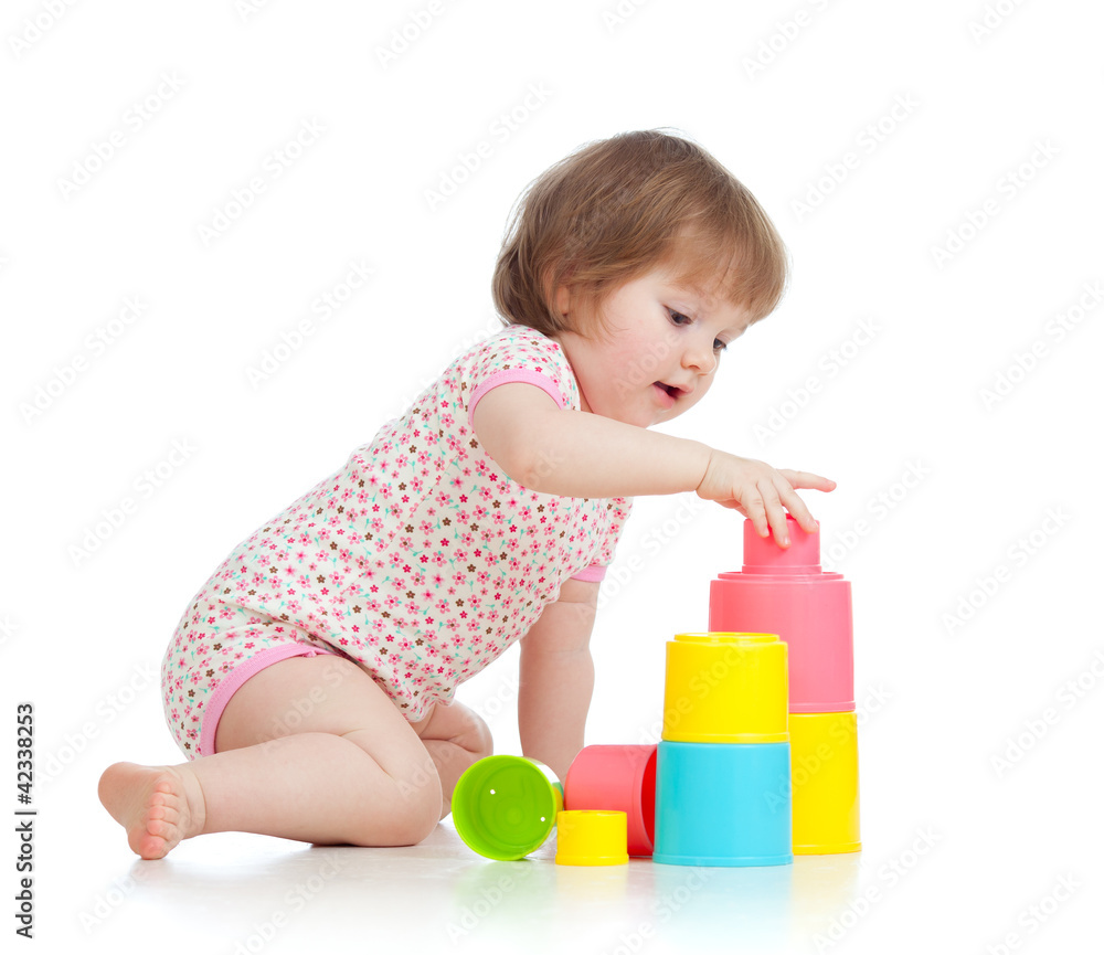 Funny little child playing with cup toys, isolated over white Funny little child playing with cup toys, isolated over white