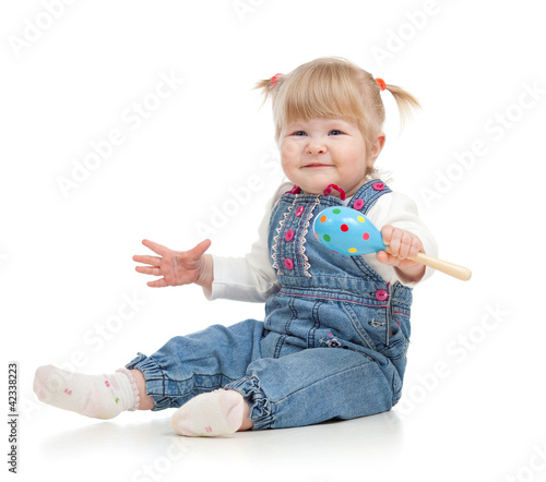 Kid playing with musical to...