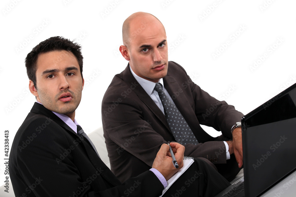 Businessmen looking at a laptop Businessmen looking at a laptop
