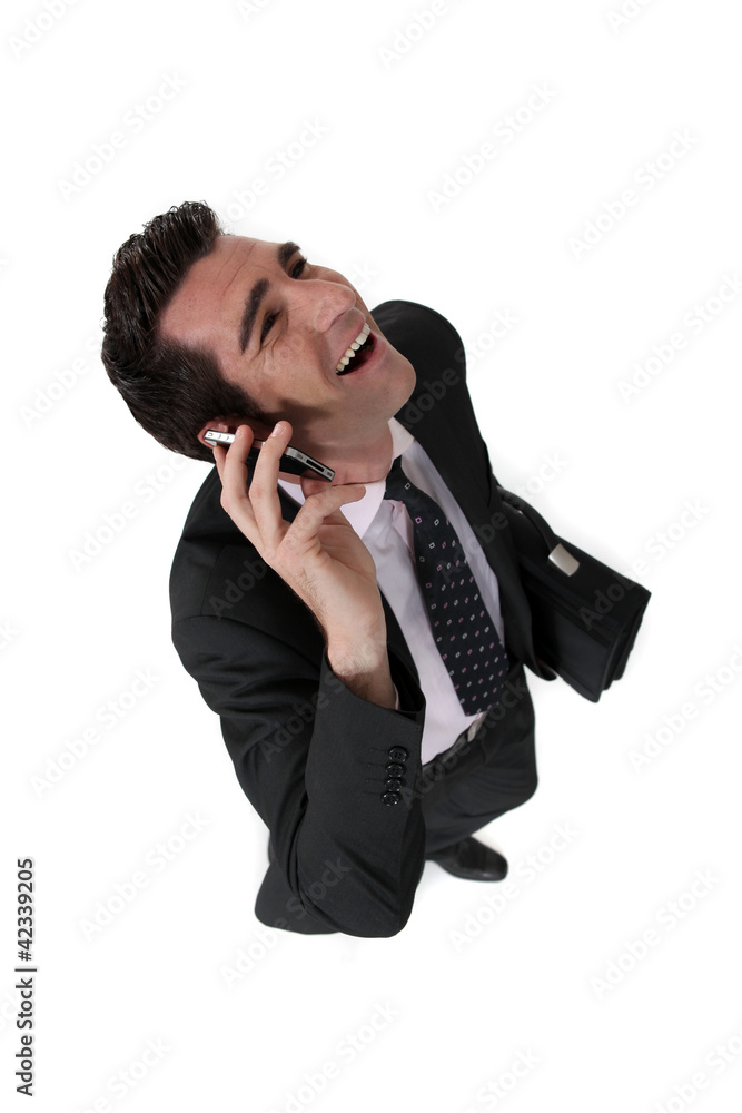 businessman talking on his cell and laughing businessman talking on his cell and laughing