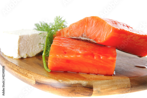 fresh smoked salmon on white plate with white cheese