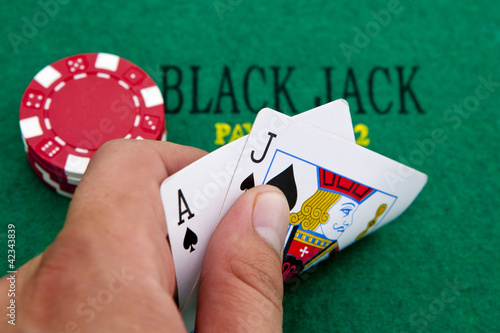 Ace of spades and black jack with red poker chips in the backgro