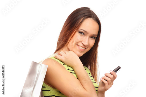Girl calling by mobile phone with shopping bags. Isolated