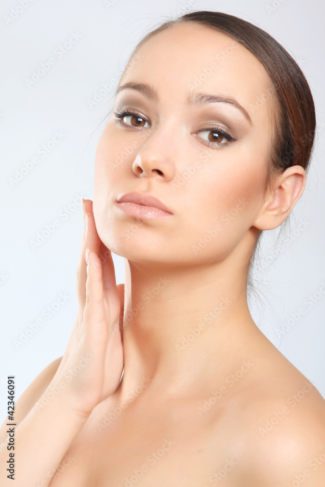 happy beautiful woman touching face and looking at camera winks happy beautiful woman touching face and looking at camera winks