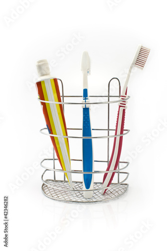 Tooth brushes beside toothpaste