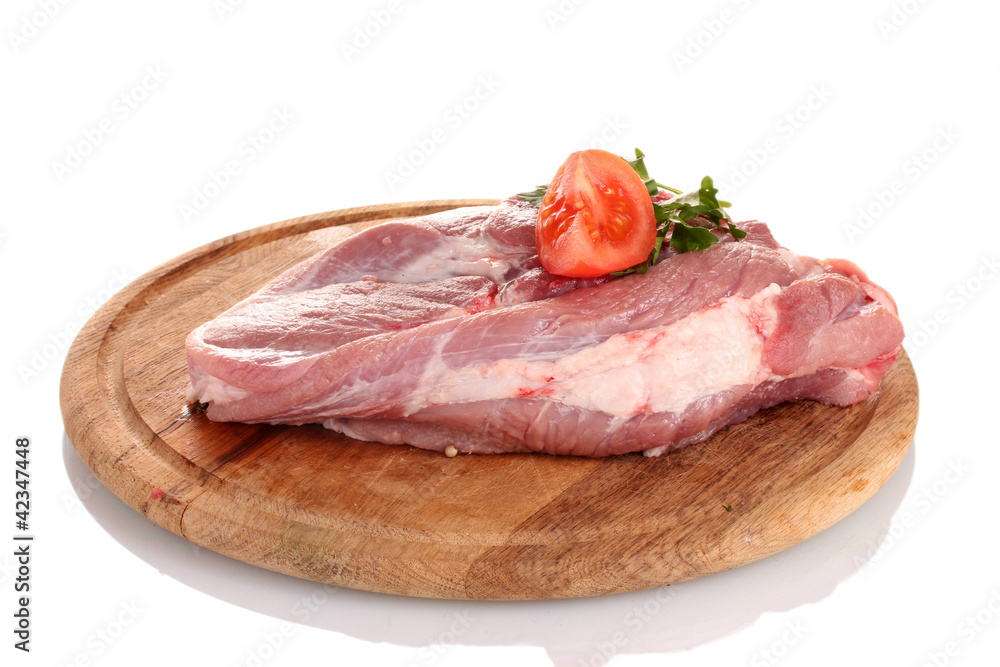 Raw meat with tomato on a wooden board isolated on white