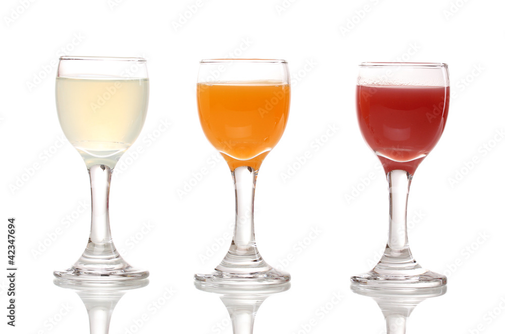 Tropical juices in glasses isolated on white Tropical juices in glasses isolated on white
