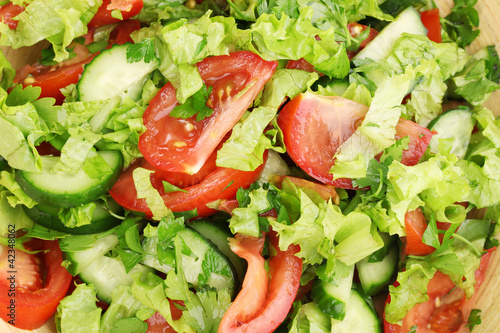 Fresh salad with tomatoes and cucumbers close-up