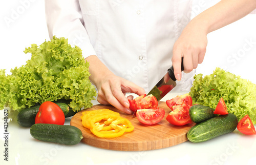 woman hands cutting vegetables on kitchen blackboard