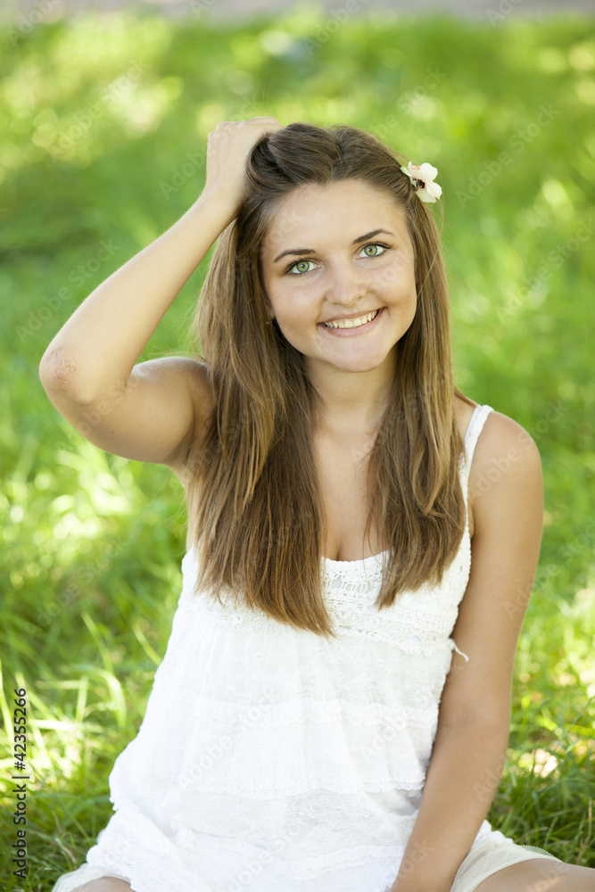 Beautiful teen girl in the park at green grass. Beautiful teen girl in the park at green grass.