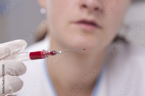Holding syringe full of blood
