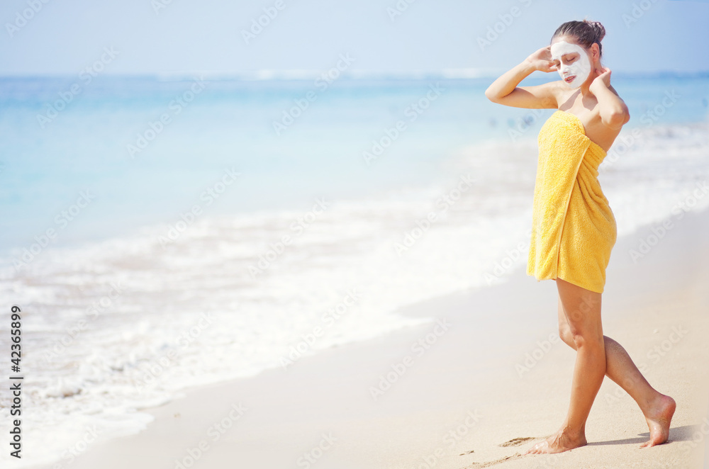 woman on the beach with mask on face woman on the beach with mask on face