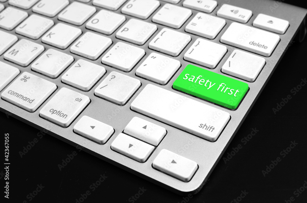 safety first concept with green key on computer keyboard