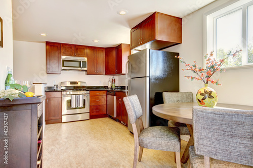 Beautiful cherry kitchen with stain steal apliances. photo