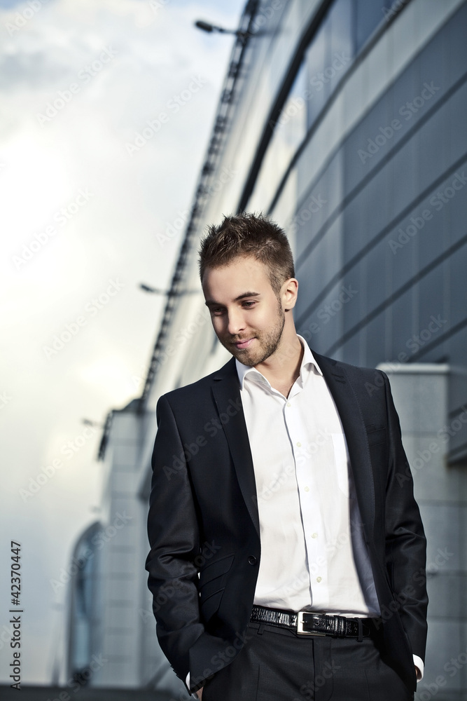 Portrait of businessman on background of office building Portrait of businessman on background of office building