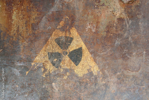 Radiation hazard sign on the rusty iron surface