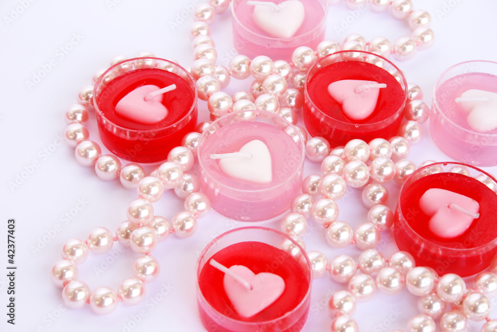 Red and pink candles with necklace