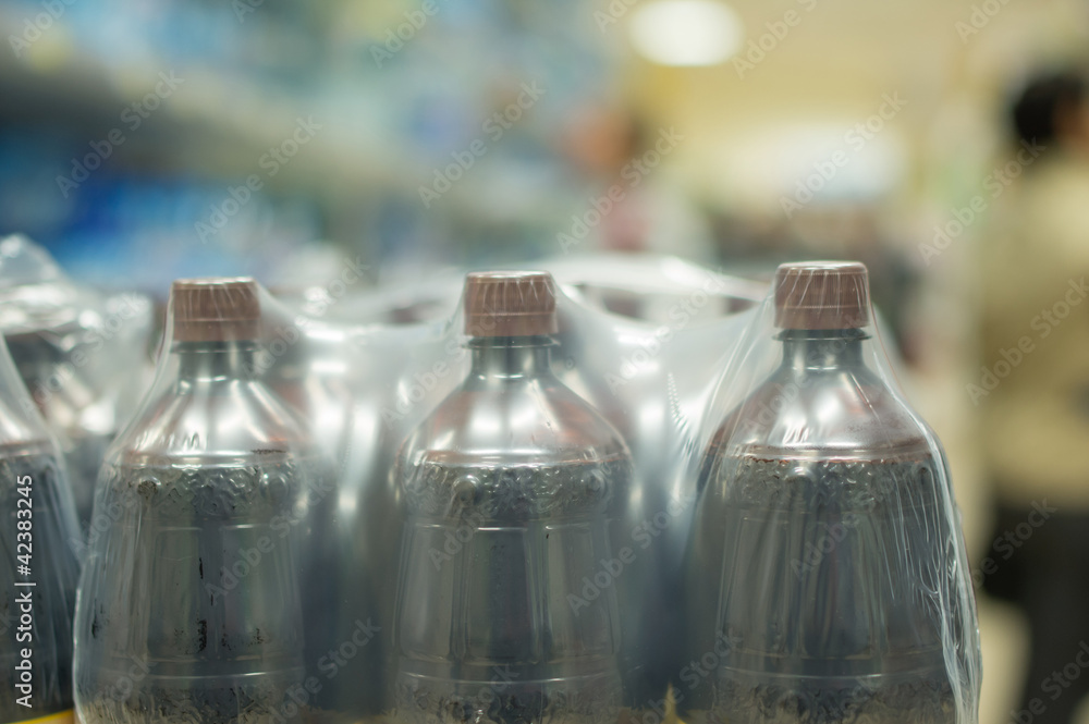 Bottles with fresh water on shelves in supermarket Bottles with fresh water on shelves in supermarket