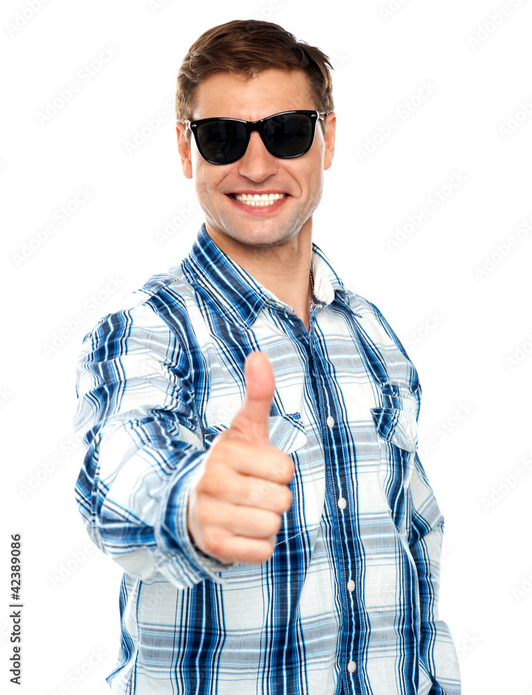 Smart young guy showing thumbs up Smart young guy showing thumbs up