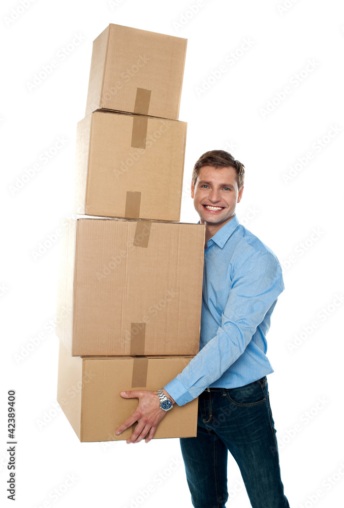 Smiling male holding stack of cartons Smiling male holding stack of cartons