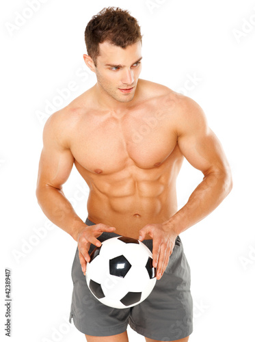 Handsome man holding soccer ball on white