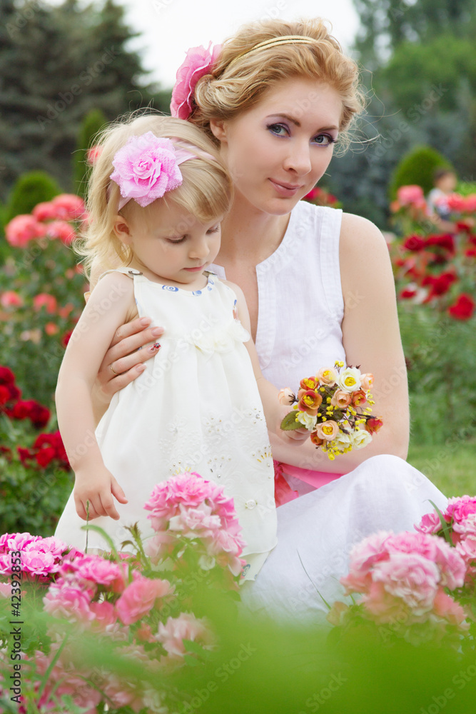 Mother and baby in rose garden Mother and baby in rose garden