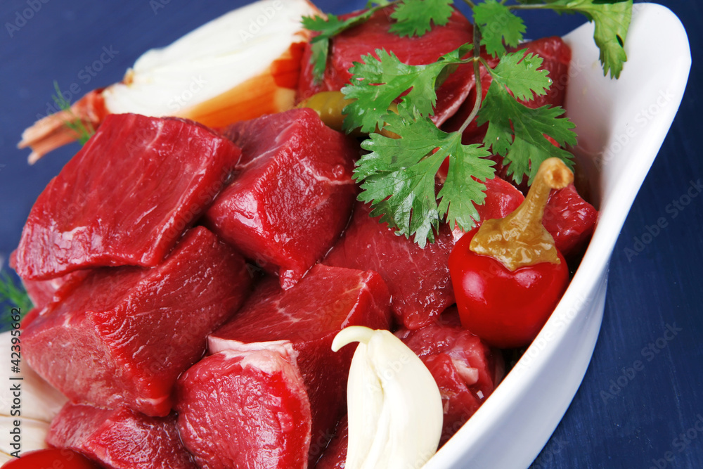 beef meat slices over white bowls ready to prepare with red pepp beef meat slices over white bowls ready to prepare with red pepp