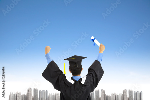 Fotografi successful graduating student with sky background