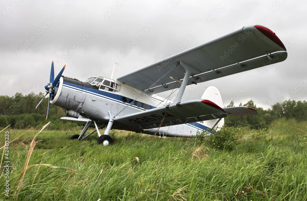 Biplane on the airfield side view Biplane on the airfield side view