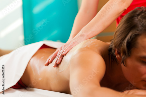 Man enjoying massage in wellness spa