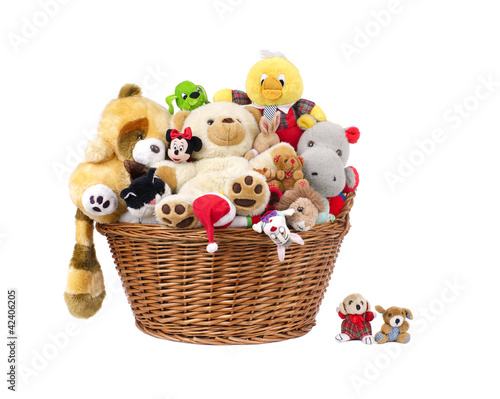 Stuffed animal toys in a basket .isolated on a white background