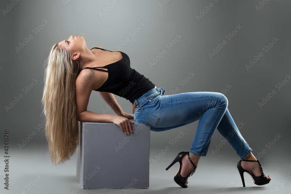 Sexy blonde woman in jeans Photos | Adobe Stock