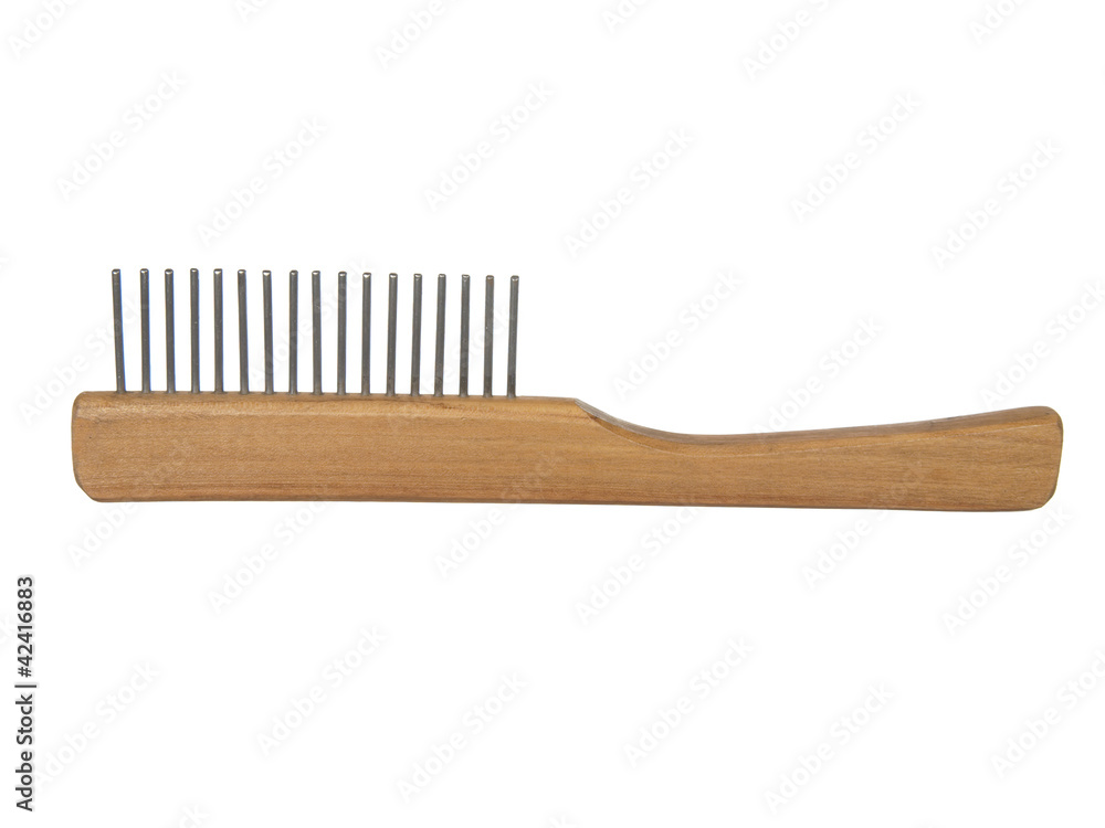 Wooden comb for a dog or cat with metal prongs, isolated on the Wooden comb for a dog or cat with metal prongs, isolated on the