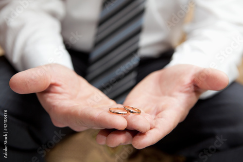 Gold wedding rings on a hand of the groom