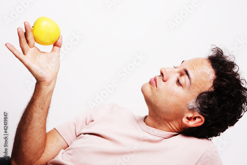 Mid adult man holding apple