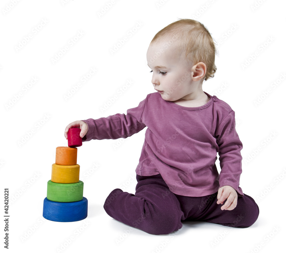 young child playing with colorful toy blocks young child playing with colorful toy blocks