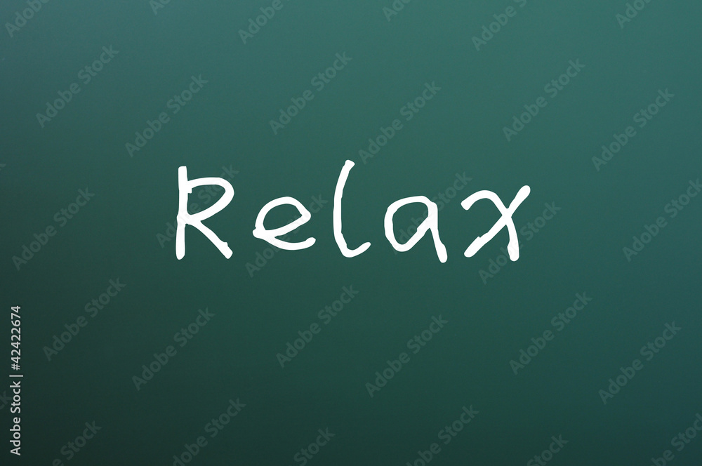 Relax - word written on a blackboard Relax - word written on a blackboard