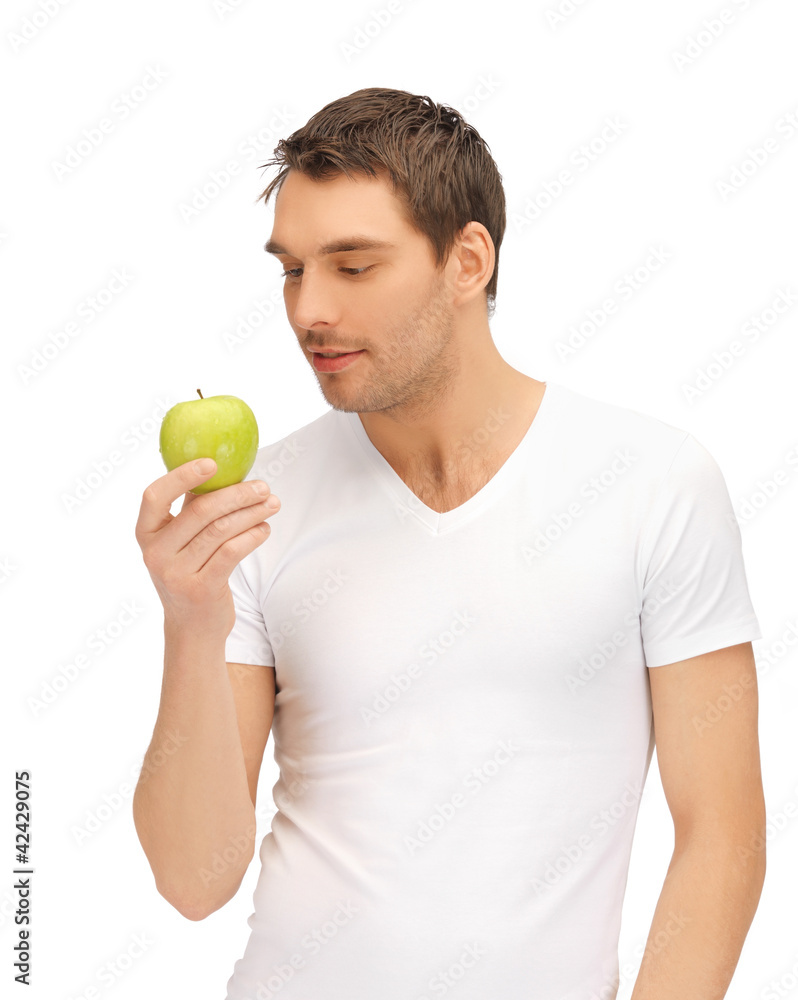 man in white shirt with green apple man in white shirt with green apple