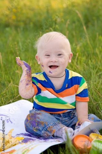 baby boy with Down syndrome painting finger paints
