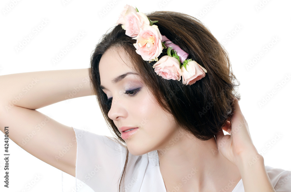 Naklejka premium Portrait of the beautiful girl with flowers in hair