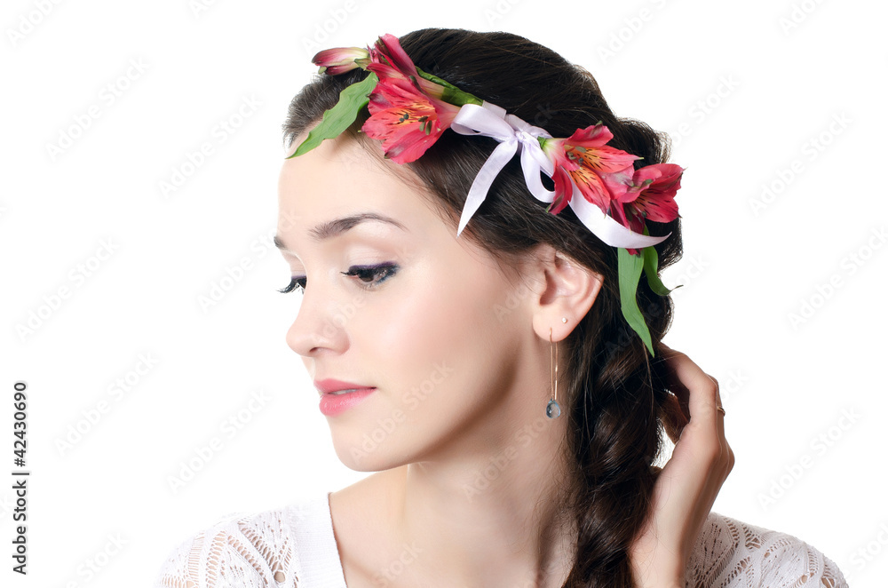 Naklejka premium Portrait of the beautiful girl with flowers in hair