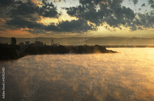 fog rising from cold lake a...